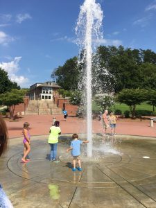 children playing in a large fountain